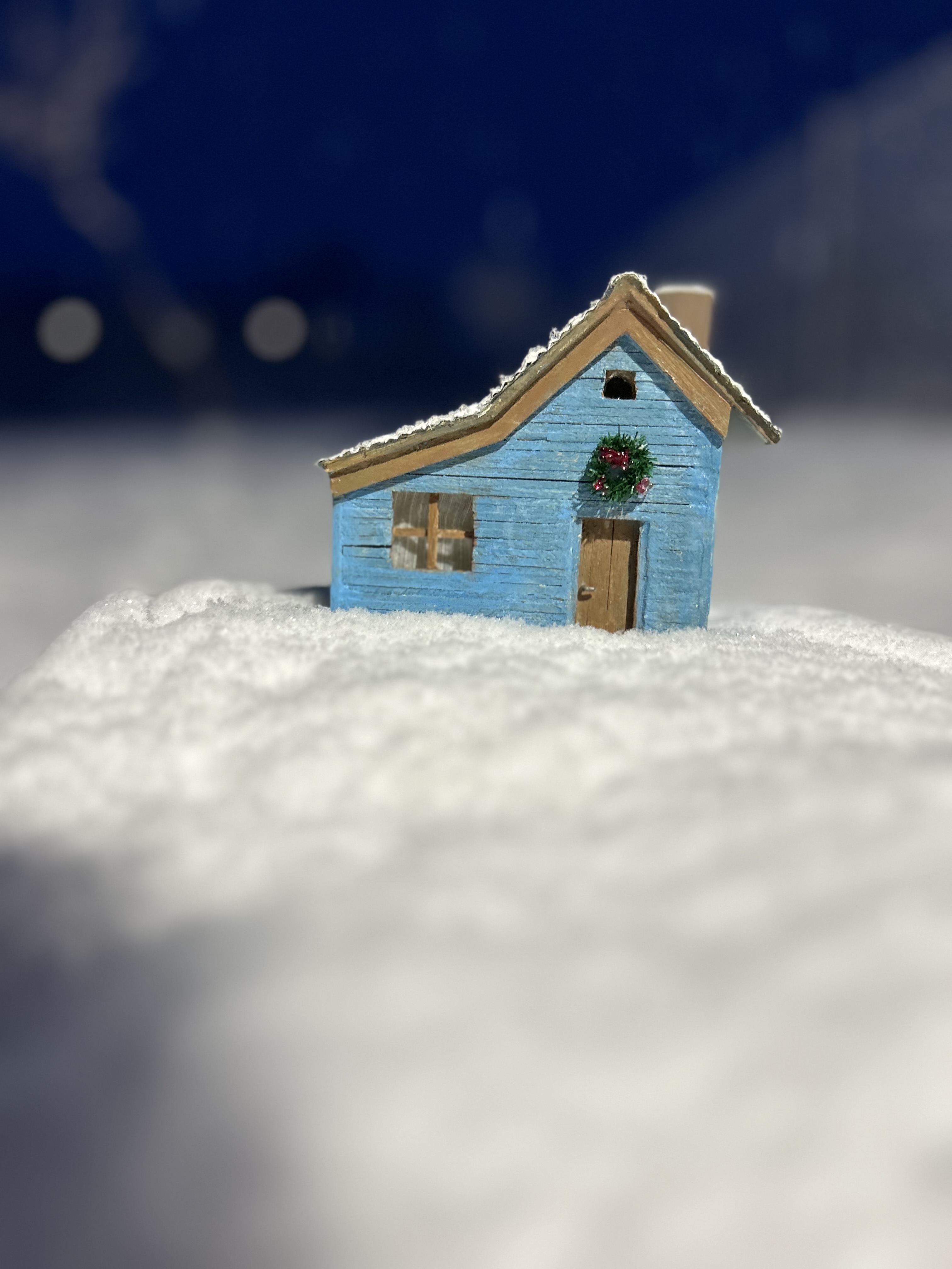 Blue cottage in the snow