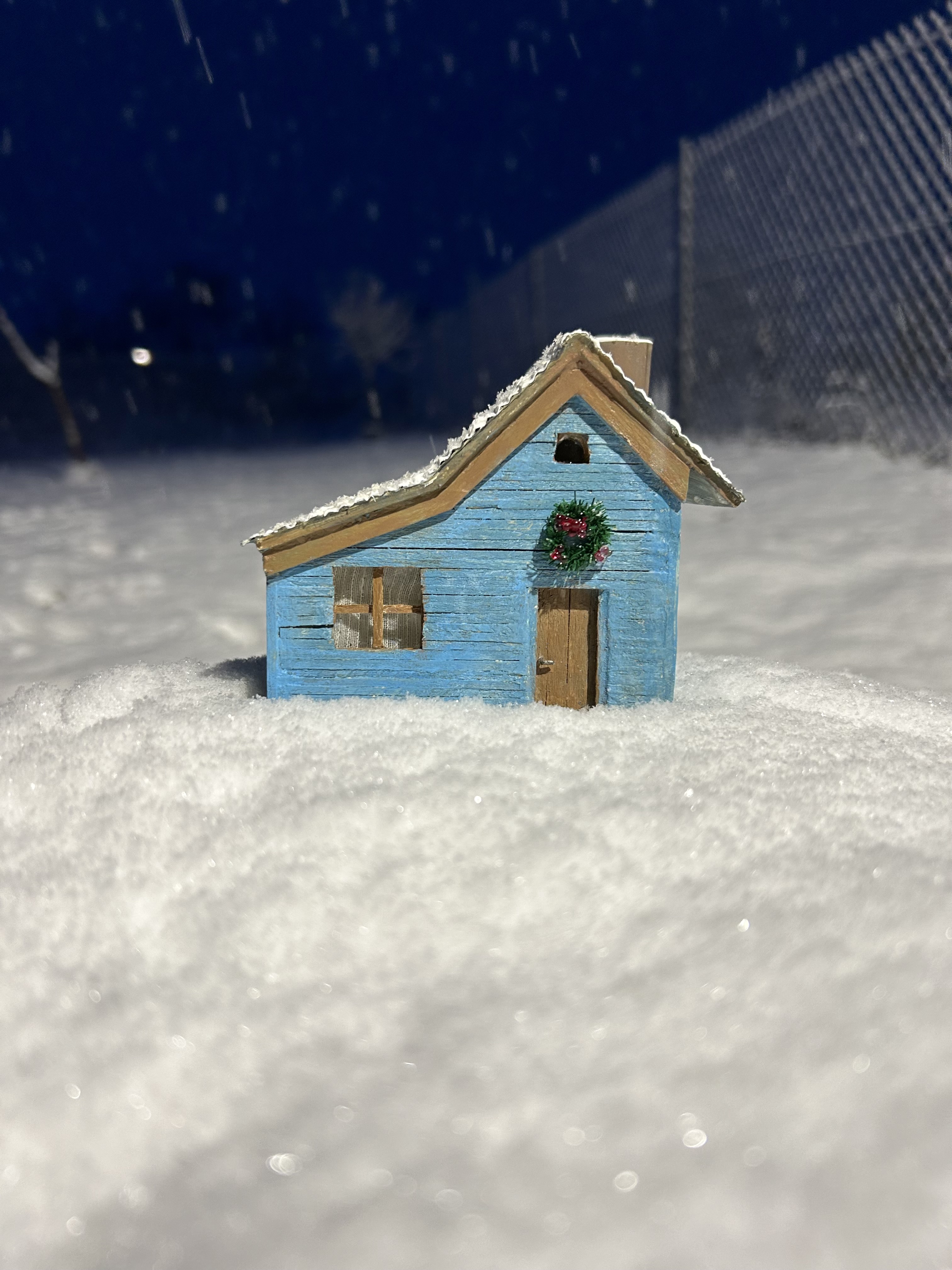 Blue cottage in the snow