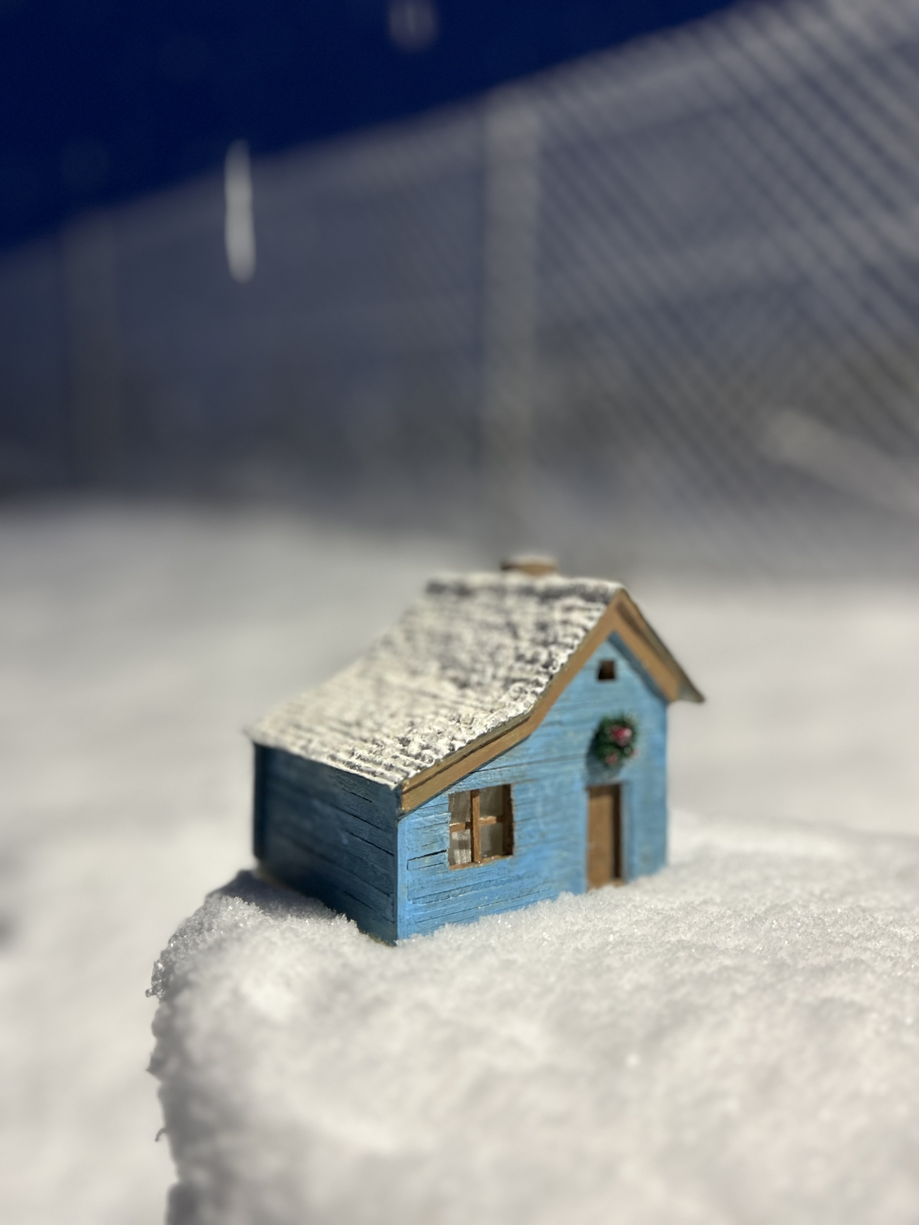 Blue cottage in the snow