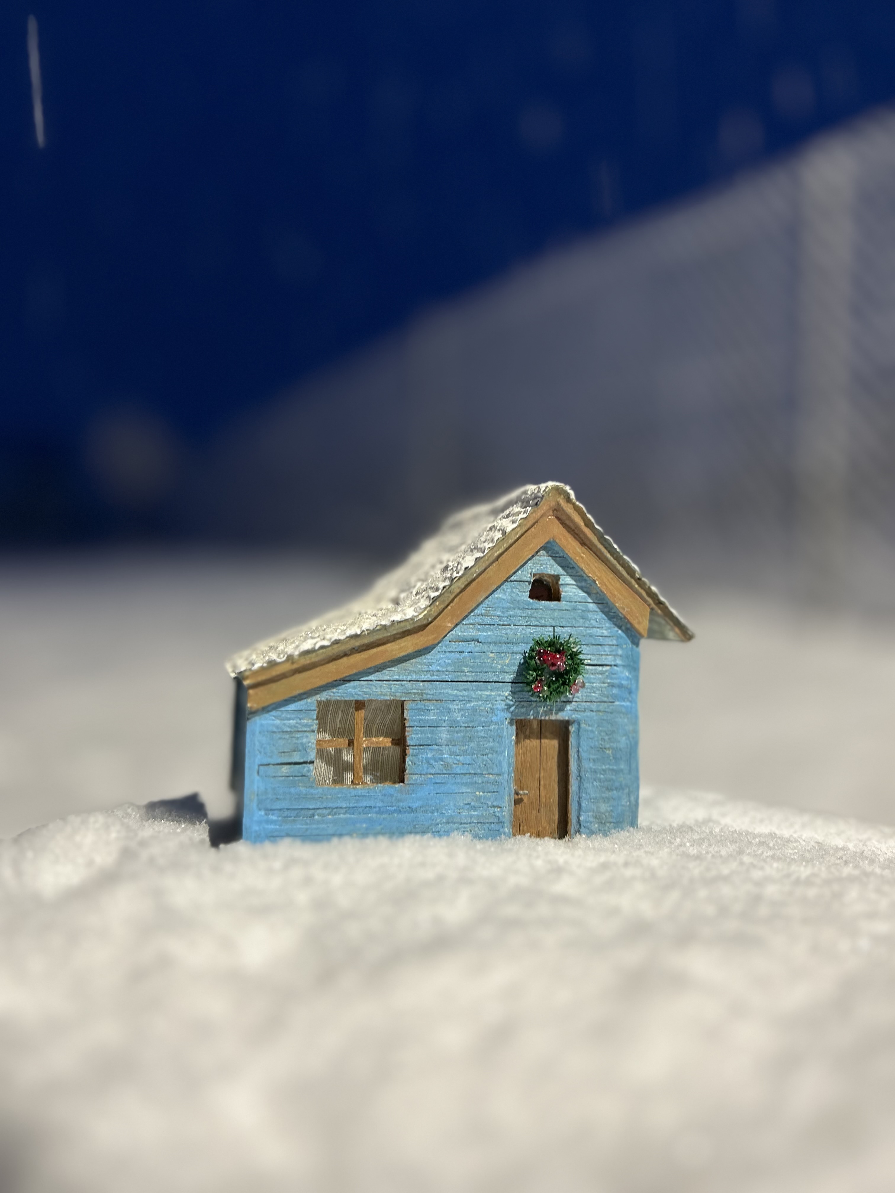 Blue cottage in the snow