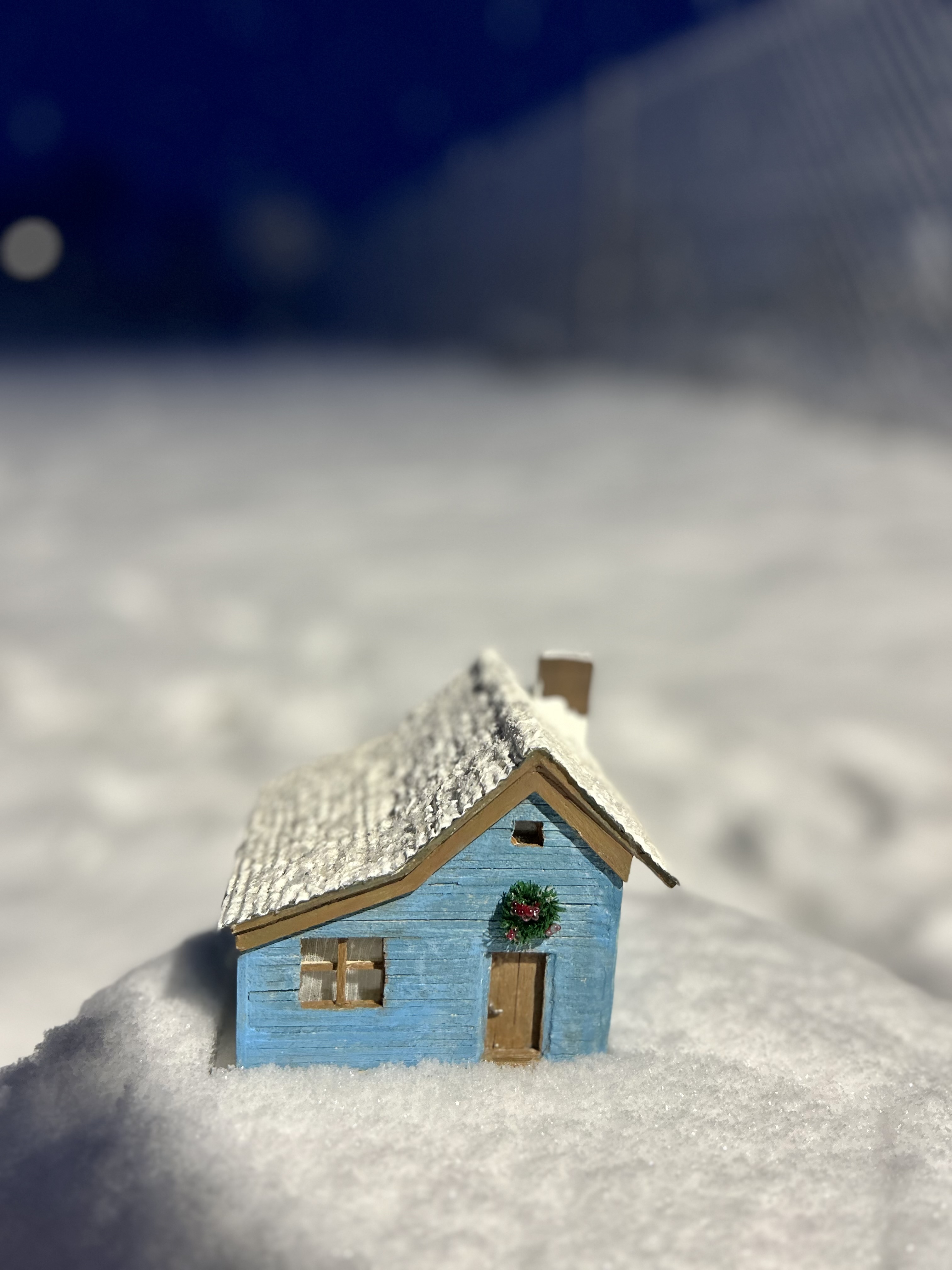 Blue cottage in the snow