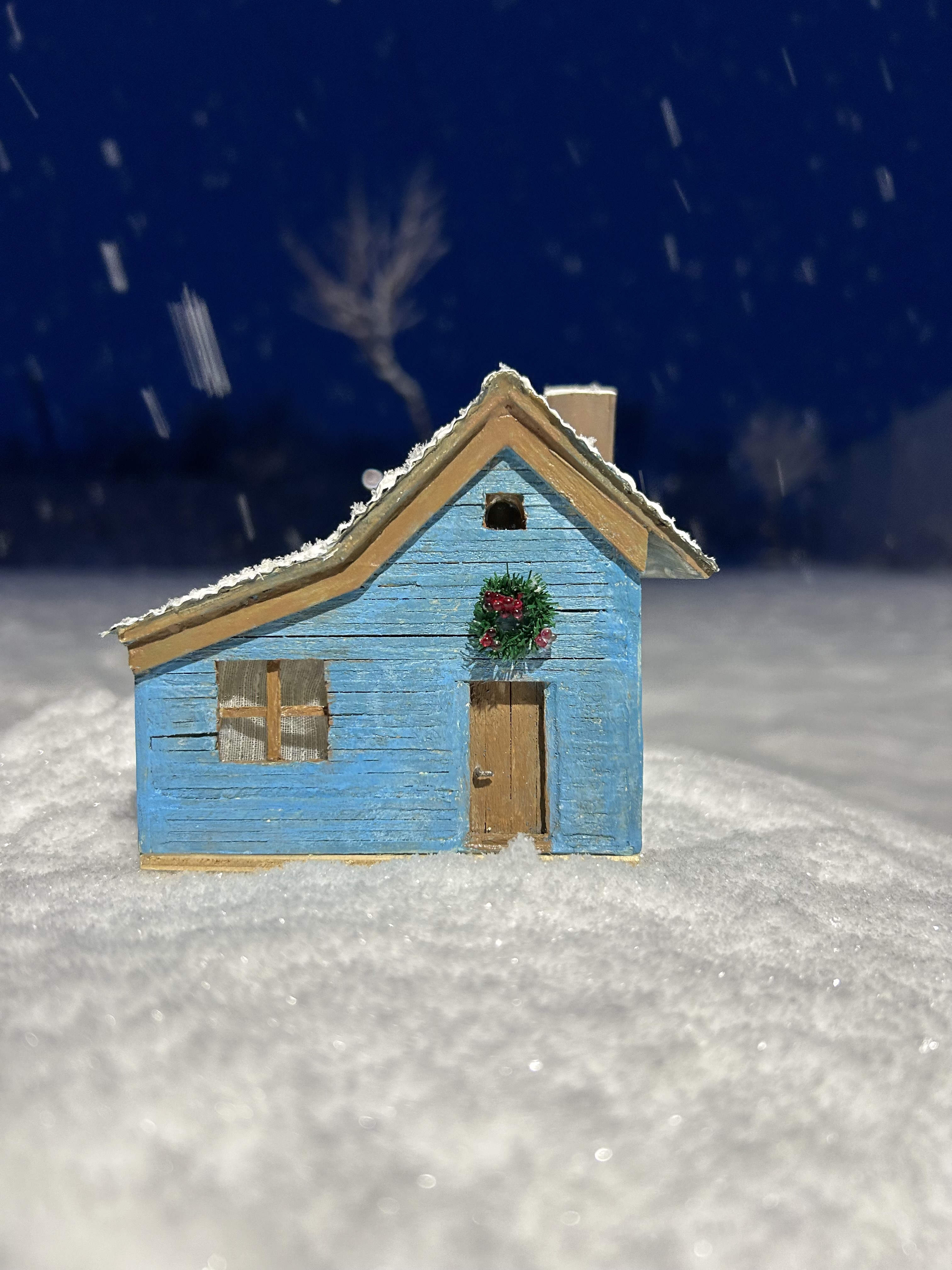 Blue cottage in the snow