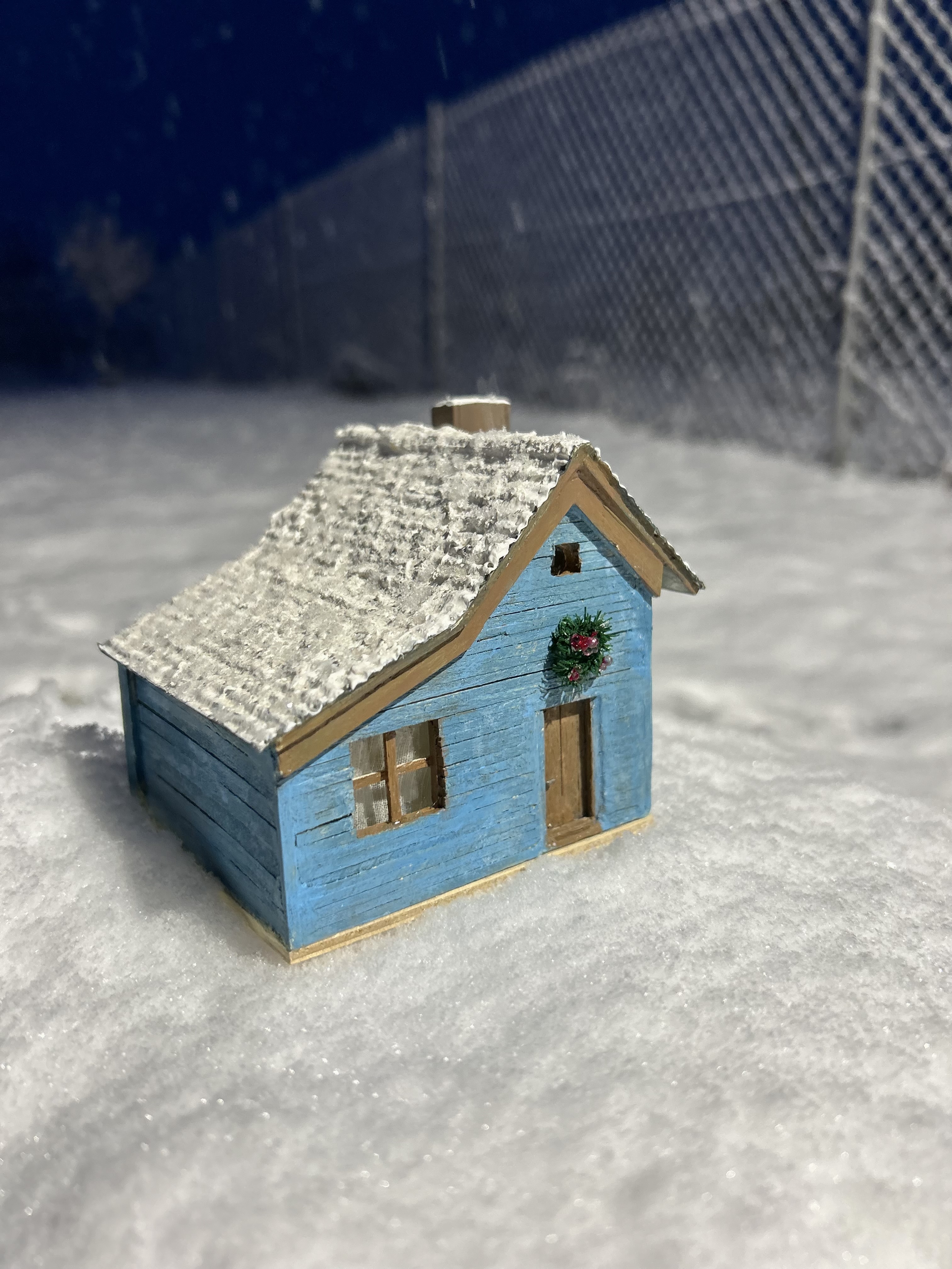 Blue cottage in the snow